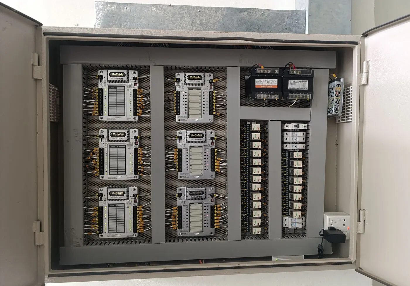 Open BMS controller panel with controller modules, relays and terminals